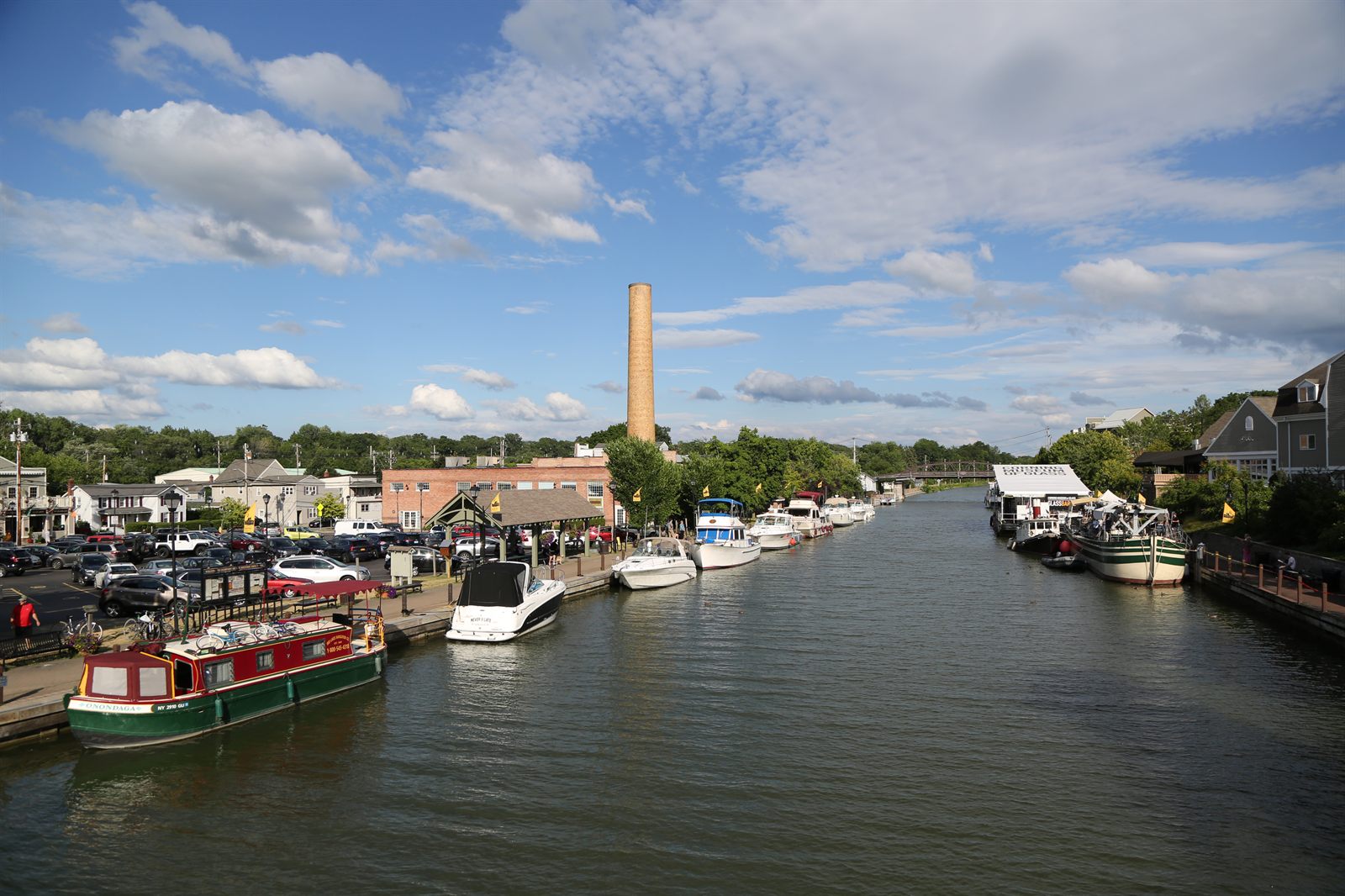 Boats docked along the Erie Canal in the village of Fairport near Rochester, with a brick chimney and shops